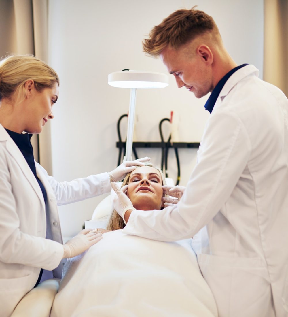 doctors-discussing-cosmetic-surgery-options-over-a-client.jpg